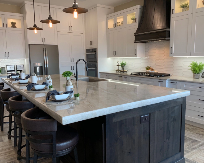 white kitchen with a marbled greyish countertop and brownish cabinets